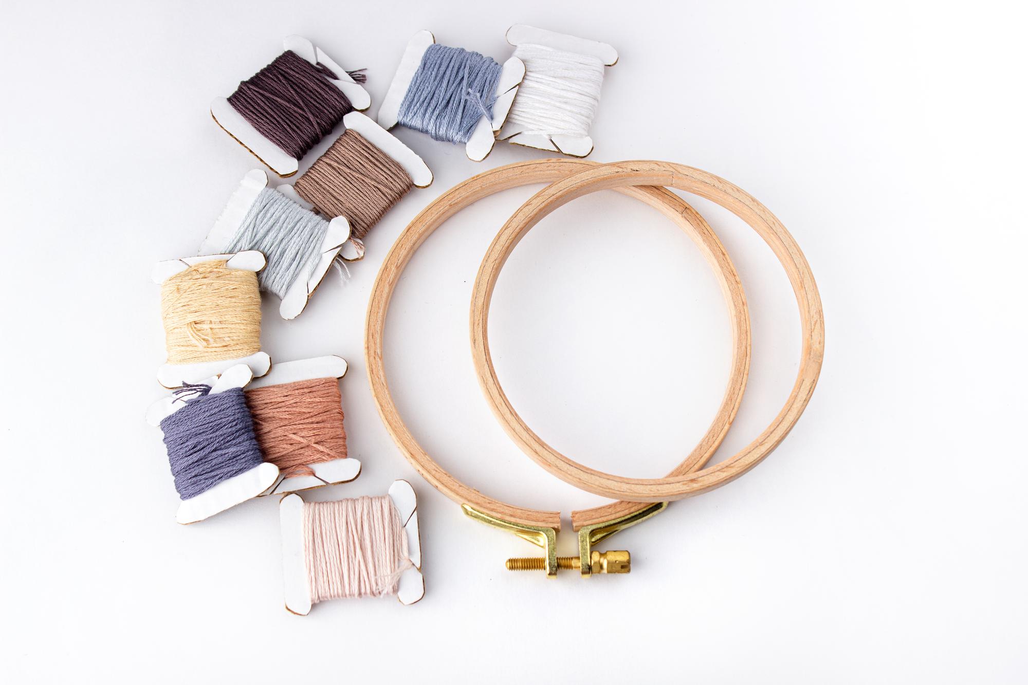 Atelier embroidery workspace with threads and hoops